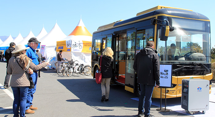 Visitors examine Brighsun EV Korea's electric bus at the outdoor showroom of the International Electric Vehicle Expo on March 16.